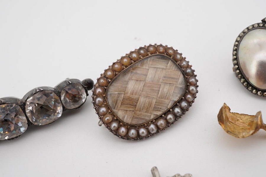 Assorted jewellery including a 19th century mourning brooch with plaited hair and split pearl set border, 22mm, a yellow metal mounted tooth, three marcasite set items and a paste set brooch.